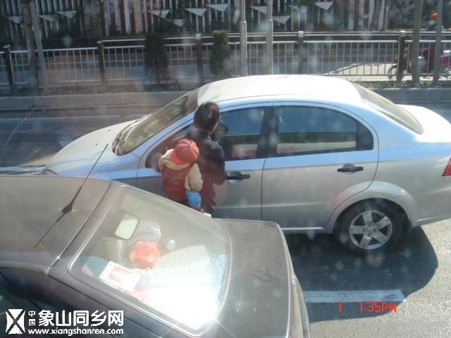 车流中乞讨的母子.JPG